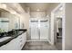 Bathroom featuring a glass shower, granite countertop and a dual sink vanity at 1928 W 67Th Pl, Denver, CO 80221