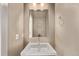 Powder room featuring a stylish mirror and vanity at 1928 W 67Th Pl, Denver, CO 80221
