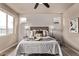 Neutral bedroom with a decorative headboard, side tables with lamps, and a plush bed at 1928 W 67Th Pl, Denver, CO 80221