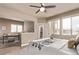 Bright bedroom features a ceiling fan, an adjacent home office, and lots of natural light at 1928 W 67Th Pl, Denver, CO 80221