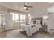 Bright bedroom with natural light, ceiling fan, and decorative rug at 1928 W 67Th Pl, Denver, CO 80221