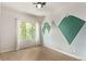 Well-lit bedroom with hardwood floors, a large window, and a scenic mountain mural at 1928 W 67Th Pl, Denver, CO 80221