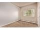Bright bedroom with large window and neutral walls ready for your personal touch at 1928 W 67Th Pl, Denver, CO 80221