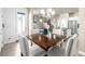 Bright dining area with modern light fixture, table setting, and open floor plan at 1928 W 67Th Pl, Denver, CO 80221