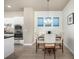 Cozy dining area featuring a stylish table, comfortable chairs, and modern lighting, perfect for Gathering meals at 1928 W 67Th Pl, Denver, CO 80221
