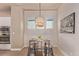 Bright dining area features modern chandelier and natural light at 1928 W 67Th Pl, Denver, CO 80221