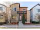 Modern two-story home with mixed siding, a covered porch, and a well-maintained front yard at 1928 W 67Th Pl, Denver, CO 80221