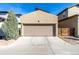 Exterior view of the two-car garage, with a concrete driveway and partial fence at 1928 W 67Th Pl, Denver, CO 80221