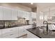 Modern kitchen with stainless steel appliances, sleek cabinetry, and dark countertops at 1928 W 67Th Pl, Denver, CO 80221