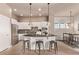Modern kitchen with stainless steel appliances, center island, and stylish pendant lighting at 1928 W 67Th Pl, Denver, CO 80221