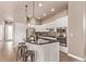 Well-lit kitchen featuring stainless steel appliances, sleek white cabinets, and a center island at 1928 W 67Th Pl, Denver, CO 80221