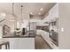 Contemporary kitchen with stainless appliances, granite counters, and white cabinets at 1928 W 67Th Pl, Denver, CO 80221