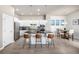 Modern kitchen featuring white cabinets, stainless steel appliances, and a sleek breakfast bar with seating at 1928 W 67Th Pl, Denver, CO 80221