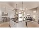 Open-concept kitchen flows into the living room, showcasing an island with granite countertop at 1928 W 67Th Pl, Denver, CO 80221