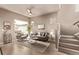 Inviting living area featuring stairs, a ceiling fan and a modern color palette at 1928 W 67Th Pl, Denver, CO 80221