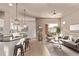 Inviting living room featuring a ceiling fan, a neutral color palette and an adjacent breakfast bar at 1928 W 67Th Pl, Denver, CO 80221