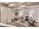Cozy living room featuring neutral walls, carpeted floors, and stylish modern furniture at 1928 W 67Th Pl, Denver, CO 80221