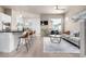 Spacious living area featuring a modern kitchen, inviting sofa, and stylish décor, perfect for relaxation at 1928 W 67Th Pl, Denver, CO 80221