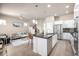 Open-concept living space featuring a modern kitchen with a living room that promotes seamless entertaining at 1928 W 67Th Pl, Denver, CO 80221