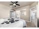 Bright main bedroom featuring a ceiling fan, walk-in closet, and views of the surrounding area at 1928 W 67Th Pl, Denver, CO 80221
