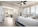 Serene main bedroom with natural light, hardwood floors, and access to en-suite bathroom at 1928 W 67Th Pl, Denver, CO 80221