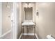 Stylish powder room with a modern sink, decorative mirror, and neutral color scheme at 1928 W 67Th Pl, Denver, CO 80221