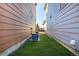 Narrow side yard features an easy-to-maintain artificial turf area and access to the patio at 1928 W 67Th Pl, Denver, CO 80221