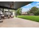 Wide backyard with a covered patio, lawn, and hot tub at 8595 S Yarrow St, Littleton, CO 80128