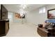 Large open basement featuring a big screen TV and an eye-catching photography art print at 8595 S Yarrow St, Littleton, CO 80128