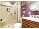 Nicely updated bathroom with tiled shower, vanity and decorative shelving at 8595 S Yarrow St, Littleton, CO 80128