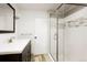 Updated bathroom featuring a modern glass enclosed shower and sleek vanity at 8595 S Yarrow St, Littleton, CO 80128