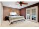 Comfortable bedroom featuring a large bed, neutral colors and direct access to a private balcony at 8595 S Yarrow St, Littleton, CO 80128