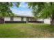 Charming home featuring a well-manicured lawn, stone accents, and mature trees at 8595 S Yarrow St, Littleton, CO 80128