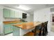 Basement kitchenette includes a breakfast bar and classic, well-maintained appliances at 8595 S Yarrow St, Littleton, CO 80128