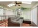Bright sunroom with a comfortable sofa and plenty of natural light from the skylights and windows at 8595 S Yarrow St, Littleton, CO 80128