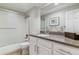 Well-lit bathroom with a shower-tub combo, granite countertop, and stylish fixtures at 7484 E Mercer Pl, Denver, CO 80237