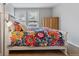 Cozy bedroom with colorful bedding, wooden wardrobe, and bright windows at 7484 E Mercer Pl, Denver, CO 80237