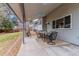 Inviting covered patio with a seating area, perfect for outdoor dining and entertaining at 7484 E Mercer Pl, Denver, CO 80237