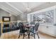 Bright dining area featuring wood floors, a round table with chairs, and a large window offering natural light at 7484 E Mercer Pl, Denver, CO 80237