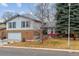 Charming two-story home with brick accents, attached garage, and well-maintained lawn at 7484 E Mercer Pl, Denver, CO 80237