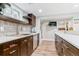 Modern kitchen featuring dark wood cabinets, stainless steel appliances, and light countertops at 7484 E Mercer Pl, Denver, CO 80237