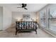 Well-lit main bedroom featuring a ceiling fan, cozy decor, and neutral tones at 7484 E Mercer Pl, Denver, CO 80237