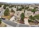Aerial view showcasing a residential neighborhood with lush trees, well-maintained homes, and winding streets at 5035 Vermillion Dr, Castle Rock, CO 80108