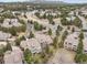 Aerial view capturing a neighborhood with winding streets, and multiple houses surrounded by mature trees at 5035 Vermillion Dr, Castle Rock, CO 80108