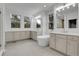 Bright bathroom featuring double vanity, a soaking tub, and large windows, perfect for relaxation at 5035 Vermillion Dr, Castle Rock, CO 80108