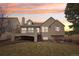 Back exterior of a tan home with deck and stairs, with a neatly kept lawn at 5035 Vermillion Dr, Castle Rock, CO 80108