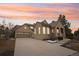 Exterior view of a home with an attached garage, a manicured lawn, and a walkway at 5035 Vermillion Dr, Castle Rock, CO 80108