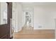 Bright foyer with light hardwood floors, white walls, and grand staircase leading to the second level at 5035 Vermillion Dr, Castle Rock, CO 80108