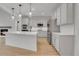 Bright kitchen boasts stainless steel appliances, white cabinets, and a spacious island with pendant lighting at 5035 Vermillion Dr, Castle Rock, CO 80108