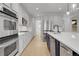 Bright kitchen with stainless appliances, ample cabinet storage, and a kitchen island with bar seating at 5035 Vermillion Dr, Castle Rock, CO 80108